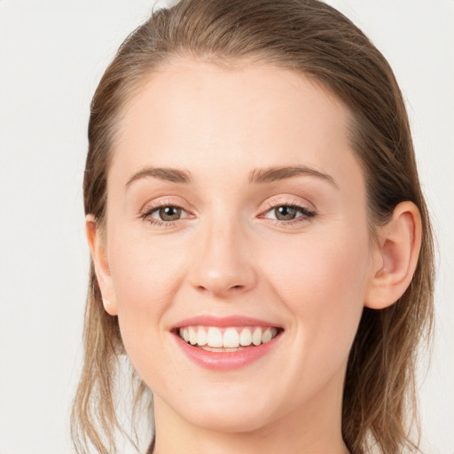 Joyful white young-adult female with long  brown hair and grey eyes