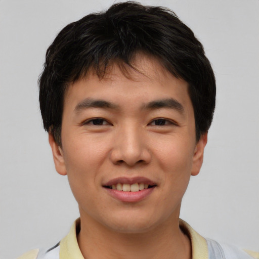 Joyful asian young-adult male with short  brown hair and brown eyes