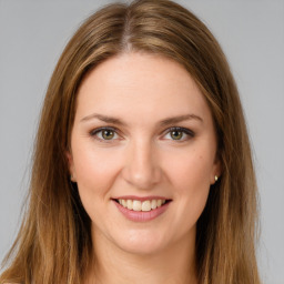 Joyful white young-adult female with long  brown hair and green eyes