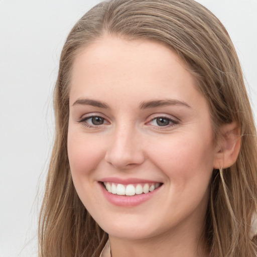 Joyful white young-adult female with long  brown hair and grey eyes