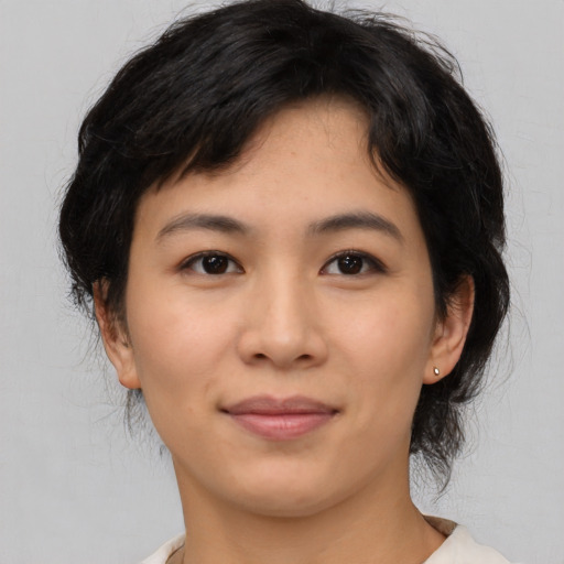 Joyful asian young-adult female with medium  brown hair and brown eyes