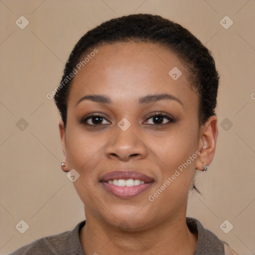 Joyful black young-adult female with short  black hair and brown eyes