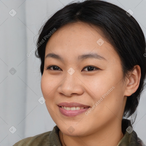 Joyful asian young-adult female with medium  brown hair and brown eyes