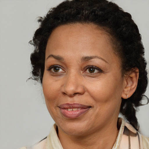 Joyful black adult female with short  brown hair and brown eyes
