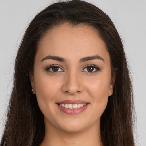 Joyful white young-adult female with long  brown hair and brown eyes