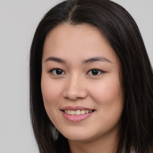 Joyful asian young-adult female with long  brown hair and brown eyes