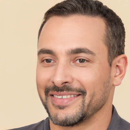 Joyful white young-adult male with short  black hair and brown eyes