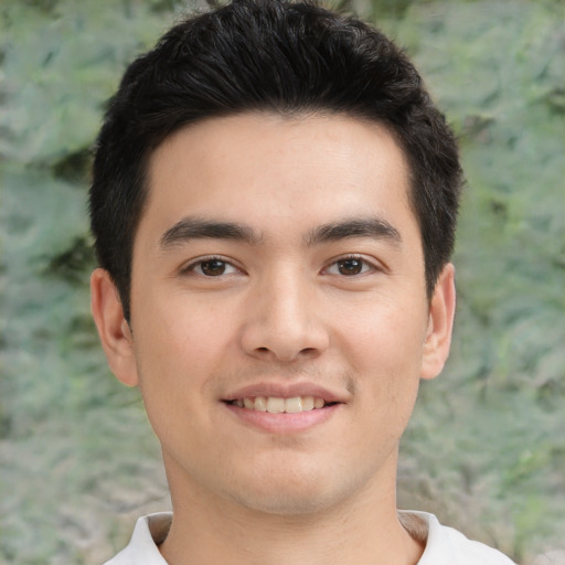 Joyful asian young-adult male with short  black hair and brown eyes
