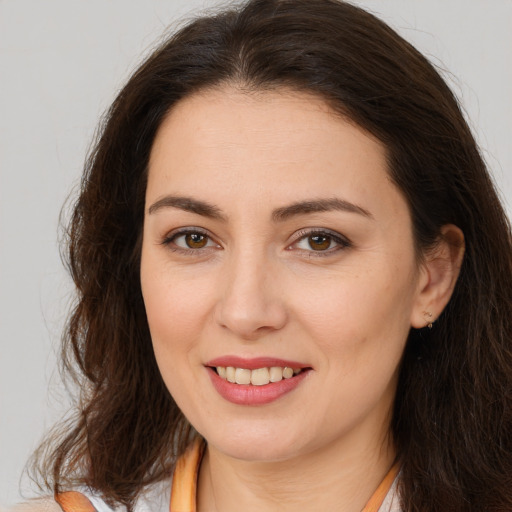 Joyful white young-adult female with long  brown hair and brown eyes