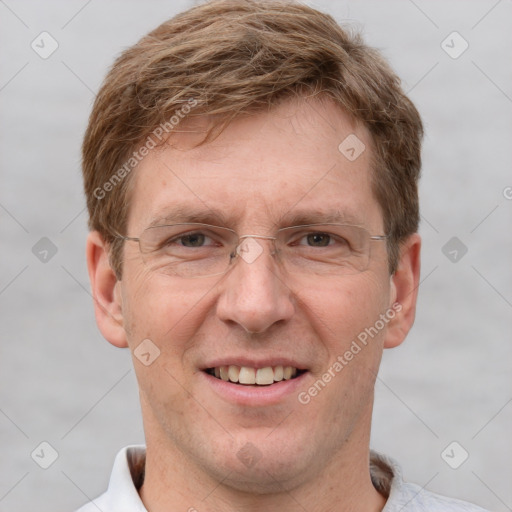 Joyful white adult male with short  brown hair and grey eyes