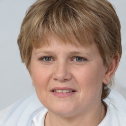 Joyful white adult female with medium  brown hair and blue eyes