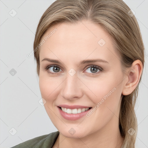 Joyful white young-adult female with medium  brown hair and grey eyes