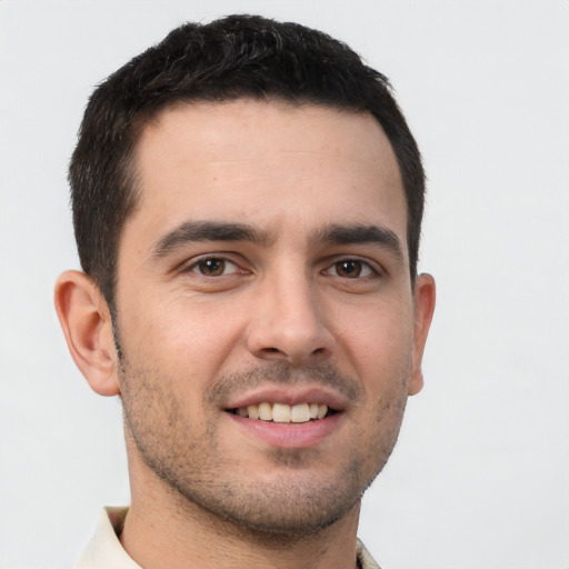 Joyful white young-adult male with short  brown hair and brown eyes