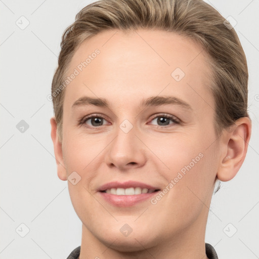 Joyful white young-adult female with short  brown hair and grey eyes