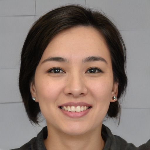 Joyful white young-adult female with medium  brown hair and brown eyes