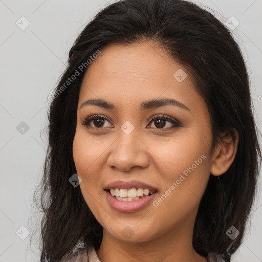 Joyful latino young-adult female with long  brown hair and brown eyes