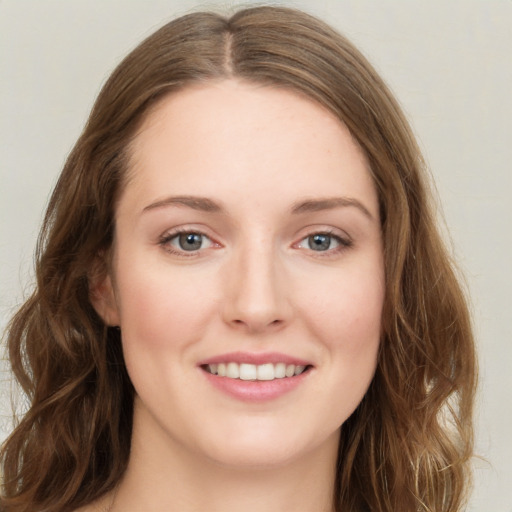 Joyful white young-adult female with long  brown hair and green eyes