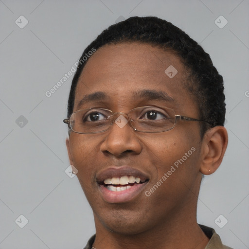 Joyful black young-adult male with short  black hair and brown eyes
