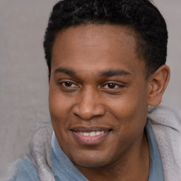 Joyful latino young-adult male with short  brown hair and brown eyes