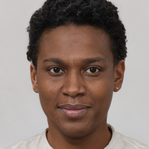 Joyful black young-adult male with short  brown hair and brown eyes