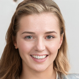 Joyful white young-adult female with long  brown hair and blue eyes