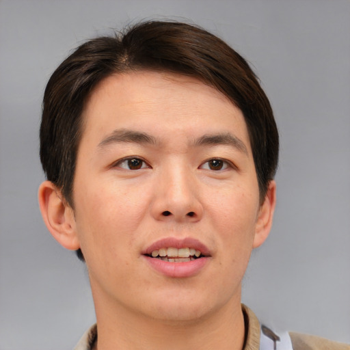 Joyful asian young-adult male with short  brown hair and brown eyes