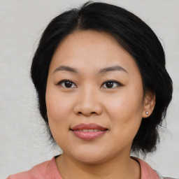 Joyful asian young-adult female with medium  black hair and brown eyes