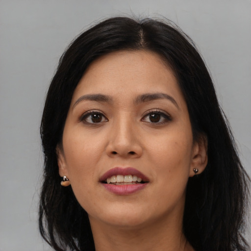 Joyful latino young-adult female with long  black hair and brown eyes