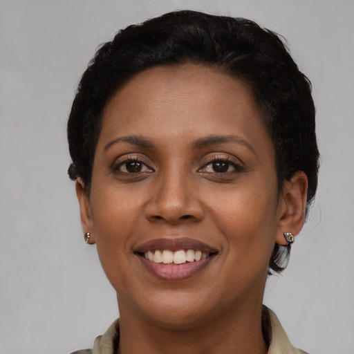 Joyful latino young-adult female with short  brown hair and brown eyes