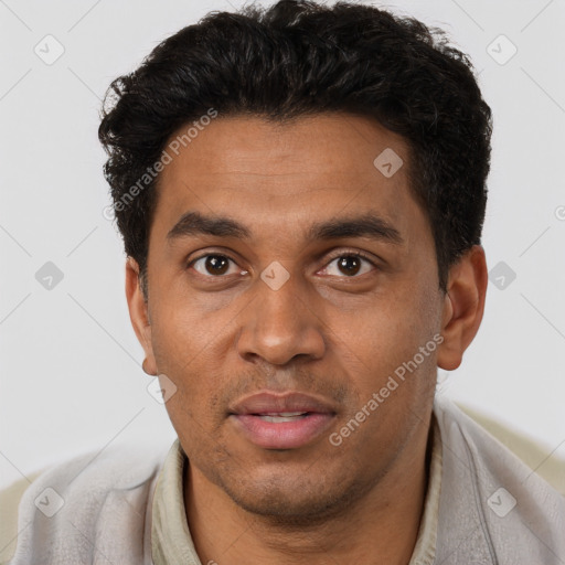 Joyful black young-adult male with short  brown hair and brown eyes