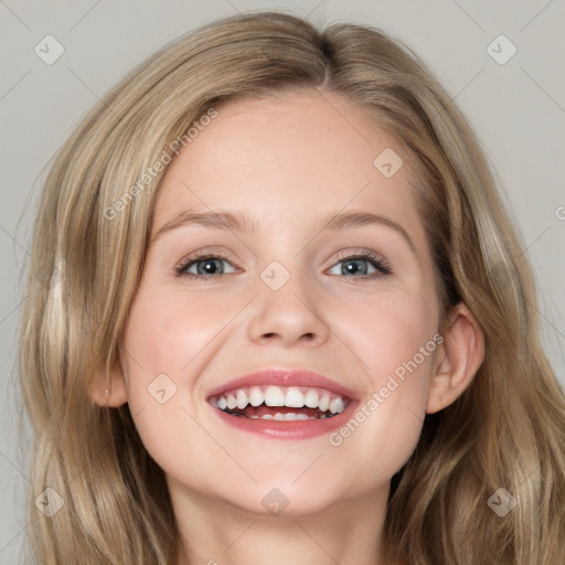 Joyful white young-adult female with long  brown hair and blue eyes