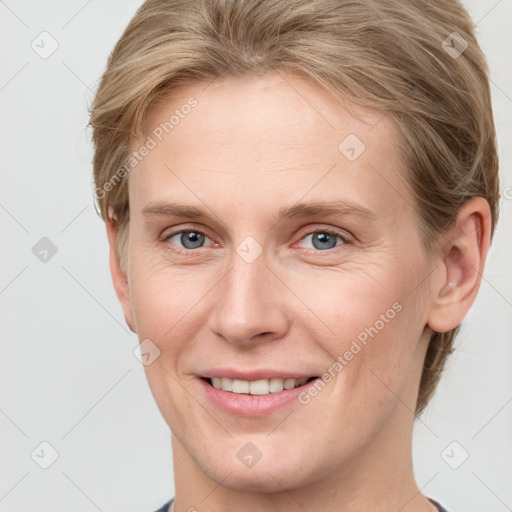 Joyful white adult female with short  brown hair and grey eyes