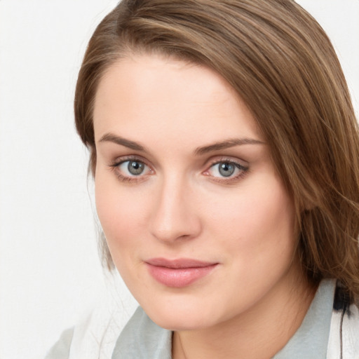 Joyful white young-adult female with medium  brown hair and blue eyes