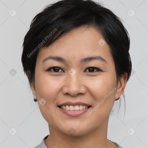 Joyful asian young-adult female with short  brown hair and brown eyes