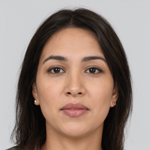 Joyful white young-adult female with long  brown hair and brown eyes