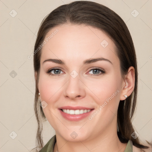 Joyful white young-adult female with medium  brown hair and grey eyes