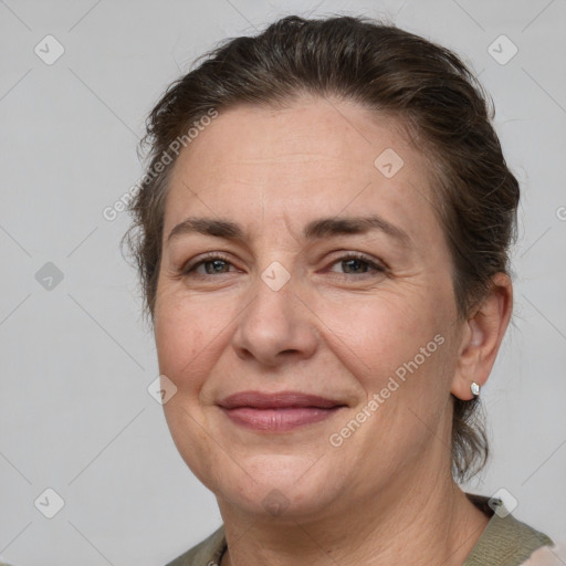 Joyful white adult female with medium  brown hair and brown eyes