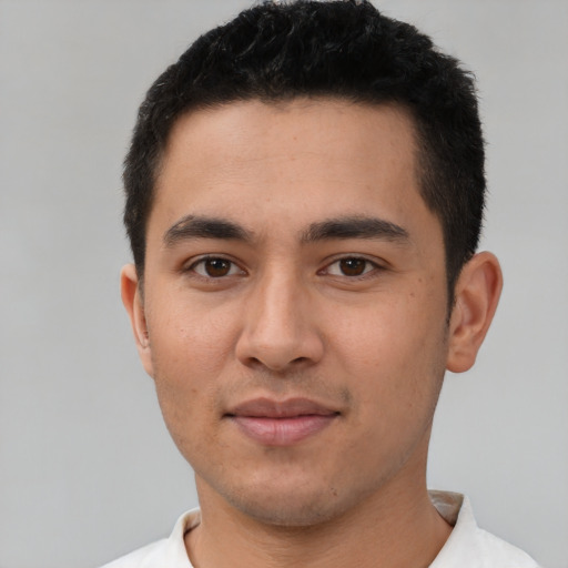 Joyful latino young-adult male with short  black hair and brown eyes