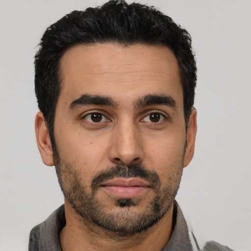 Neutral latino young-adult male with short  black hair and brown eyes