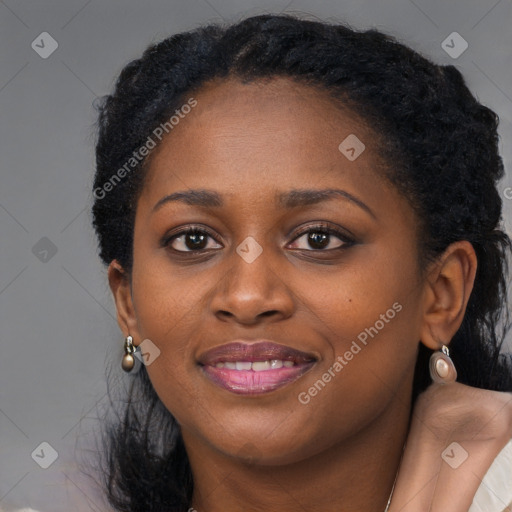 Joyful black young-adult female with long  black hair and brown eyes