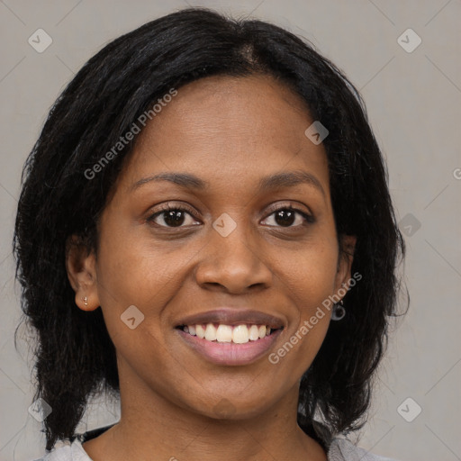 Joyful black young-adult female with medium  brown hair and brown eyes