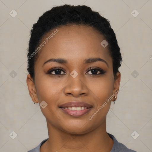 Joyful black young-adult female with short  black hair and brown eyes