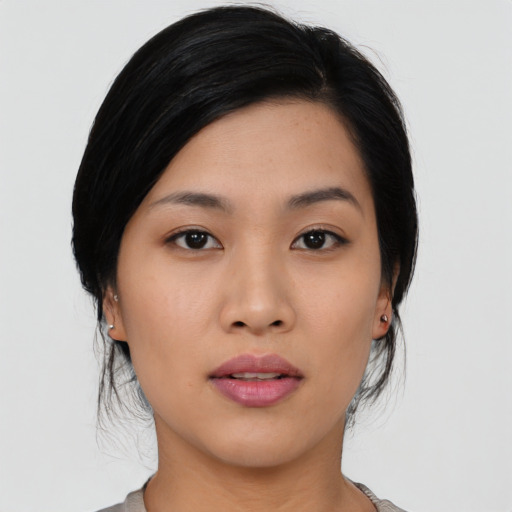 Joyful asian young-adult female with medium  black hair and brown eyes