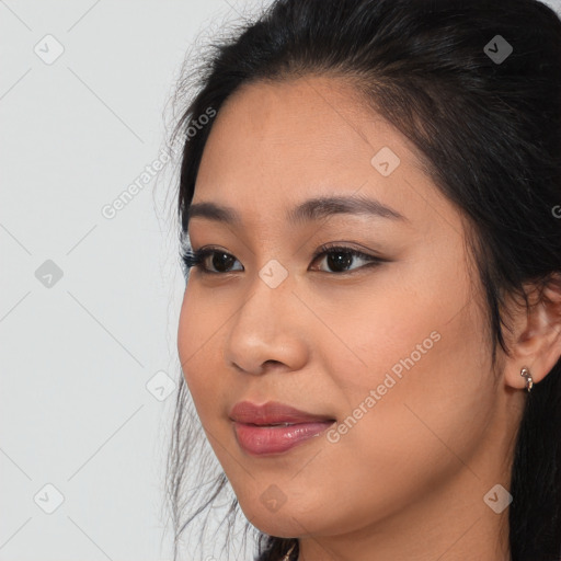 Joyful asian young-adult female with long  brown hair and brown eyes