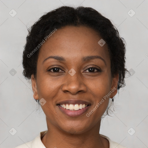 Joyful black young-adult female with short  brown hair and brown eyes