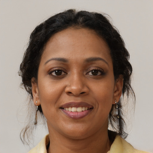 Joyful latino adult female with medium  brown hair and brown eyes