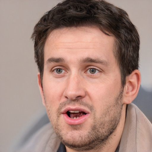 Joyful white adult male with short  brown hair and brown eyes