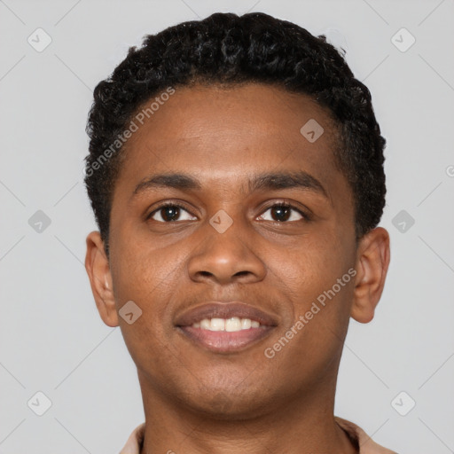 Joyful black young-adult male with short  brown hair and brown eyes