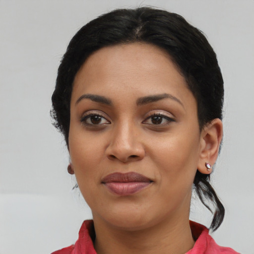 Joyful latino young-adult female with medium  black hair and brown eyes