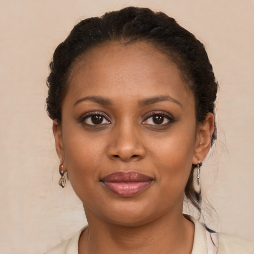 Joyful black young-adult female with short  brown hair and brown eyes